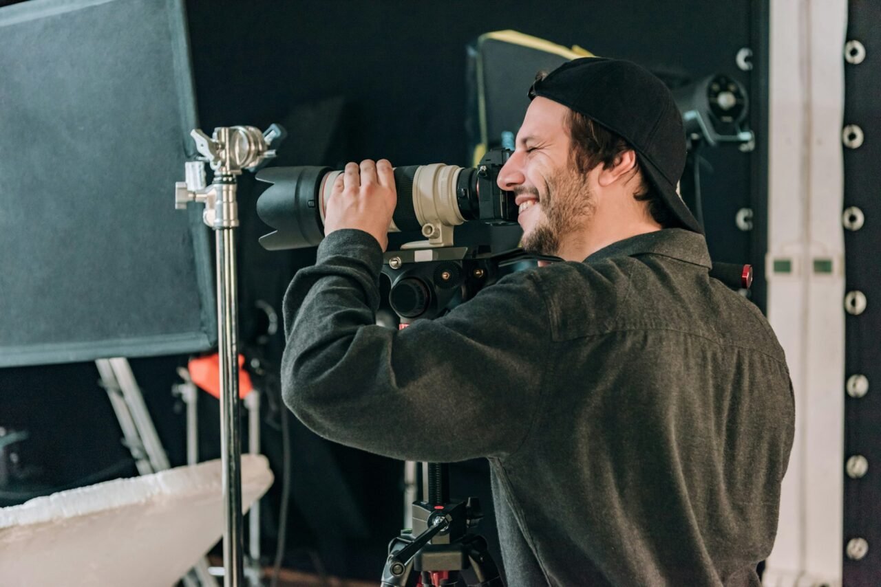 videographer-with-camera-in-photo-studio.